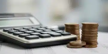 Calculator and coins representing 401(k) contribution limit calculations for 2026.